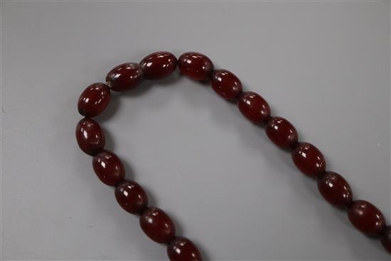 A single strand graduated simulated cherry amber bead necklace, 72cm, gross 61 grams.